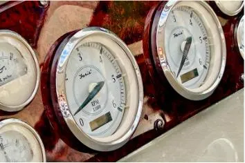 Slide: The Image of Close-up of 2007 Regal Commodore 3760 IB boat gauges on a wooden dashboard. - 5