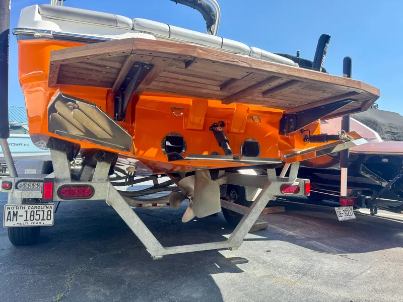 Slide: The Image of 2018 MasterCraft NXT22 boat on trailer, rear view, orange hull, North Carolina license plate. - 4