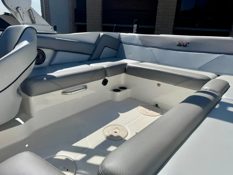 Slide: The Image of 2018 MasterCraft NXT22 boat interior with gray seating and cup holders. - 5