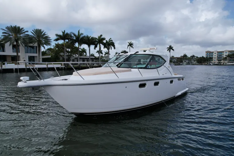 Slide: The Image of 2008 Tiara Yachts 3500 Sovran cruising on a scenic waterway with palm trees. - 2