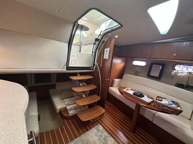 Slide: The Image of 2008 Tiara Yachts 3500 Sovran interior with wooden steps, seating, and elegant design. - 22