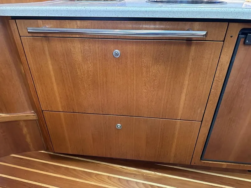 Slide: The Image of 2008 Tiara Yachts 3500 Sovran interior with wooden cabinetry and sleek countertop. - 24