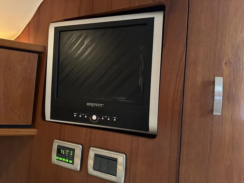 Slide: The Image of 2008 Tiara Yachts 3500 Sovran interior with wall-mounted TV and control panel. - 26