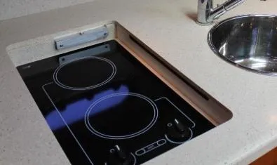 Slide: The Image of 2008 Tiara Yachts 3500 Sovran kitchen with electric stove and sink. - 30