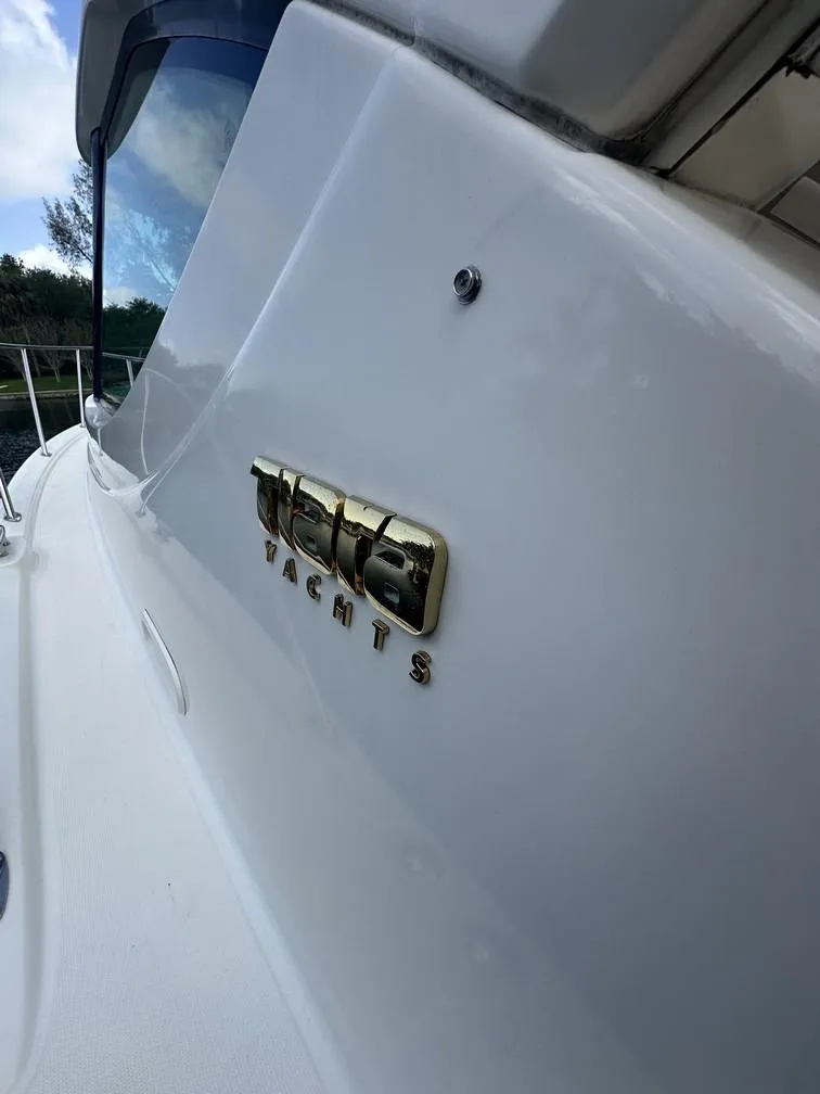 Slide: The Image of 2008 Tiara Yachts 3500 Sovran, sleek white exterior with logo detail. - 32