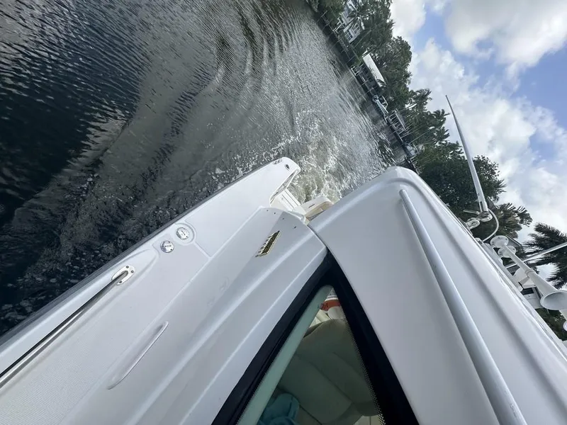 Slide: The Image of 2008 Tiara Yachts 3500 Sovran cruising on a calm waterway under a partly cloudy sky. - 44