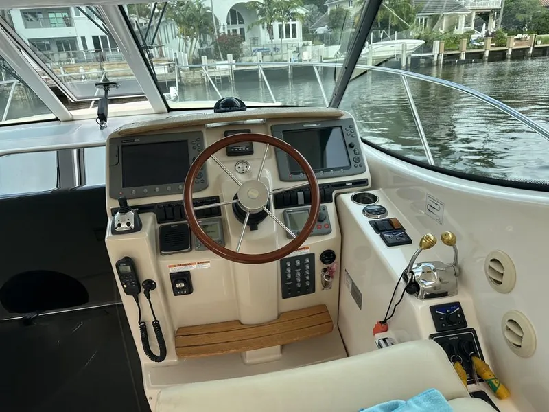 Slide: The Image of 2008 Tiara Yachts 3500 Sovran helm with dual displays and wooden steering wheel. - 5