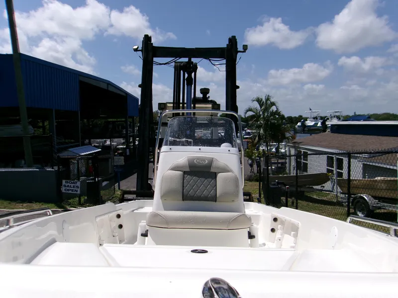 Slide: The Image of 2025 Key West 1720 boat on forklift at marina, clear sky background. - 6
