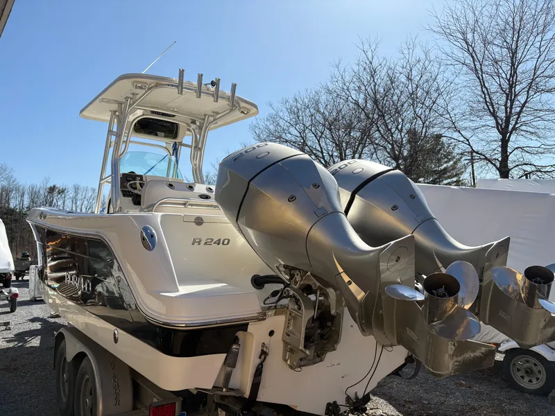 Slide: The Image of 2007 Robalo R240 Center Console boat with dual outboard engines on a trailer. - 5