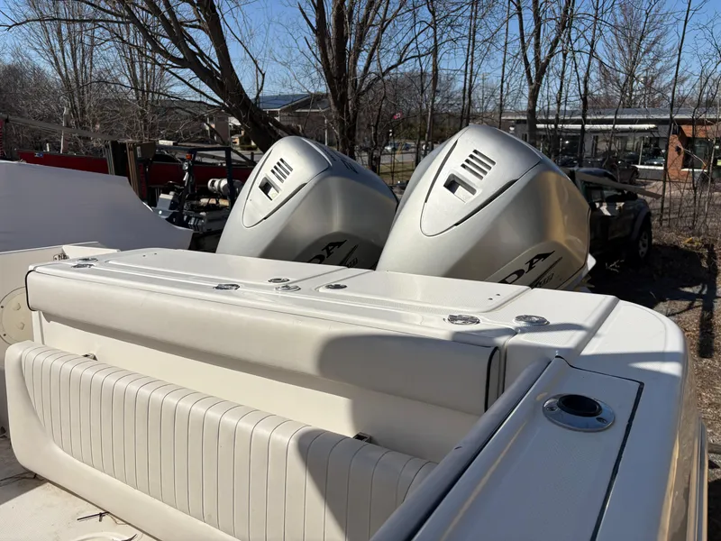 Slide: The Image of 2007 Robalo R240 Center Console boat with dual outboard engines, parked outdoors. - 6