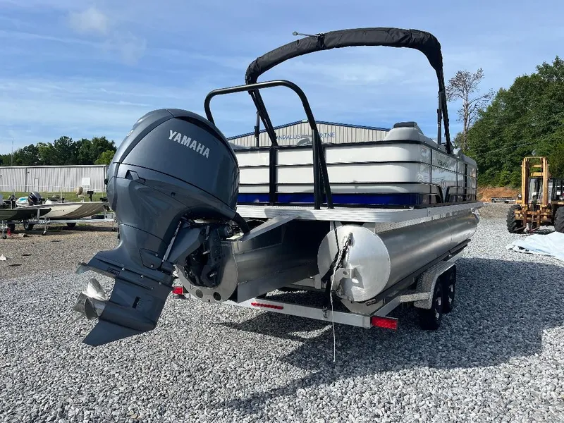 Slide: The Image of 2025 Veranda VS22RC pontoon boat with Yamaha outboard motor on gravel lot. - 1