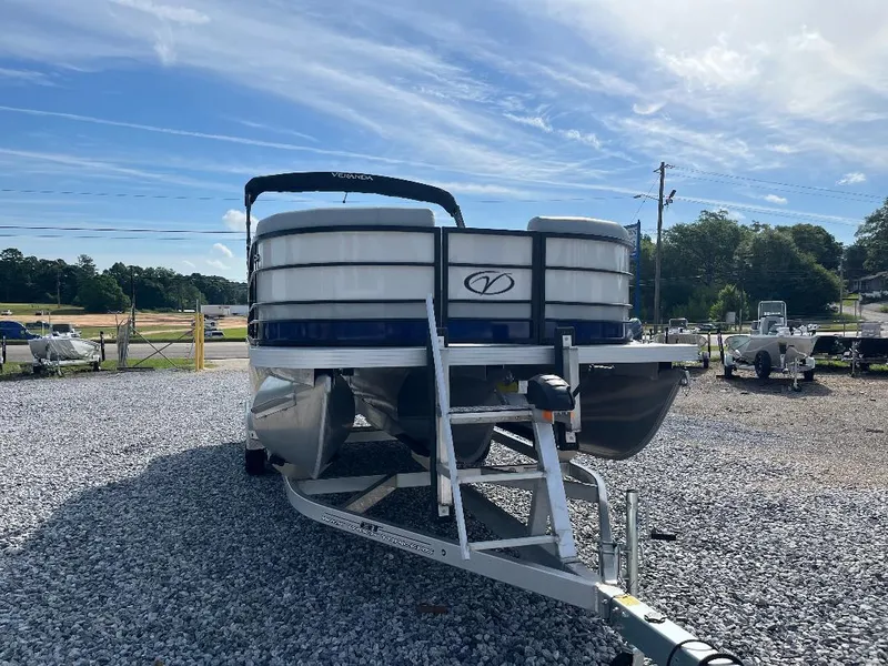 Slide: The Image of 2025 Veranda VS22RC pontoon boat on trailer, parked on gravel lot under blue sky. - 4