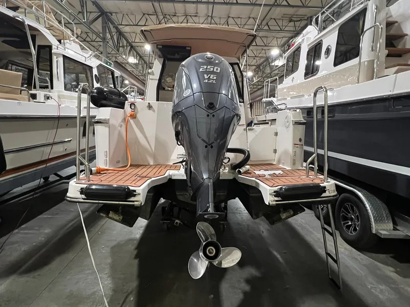 Slide: The Image of 2023 Ranger Tugs R-25 boat with 250 V6 engine in a showroom. - 3