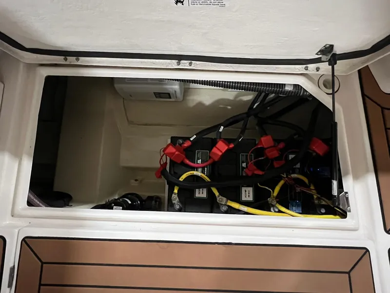 Slide: The Image of 2023 Ranger Tugs R-25 battery compartment with wiring and connections. - 5