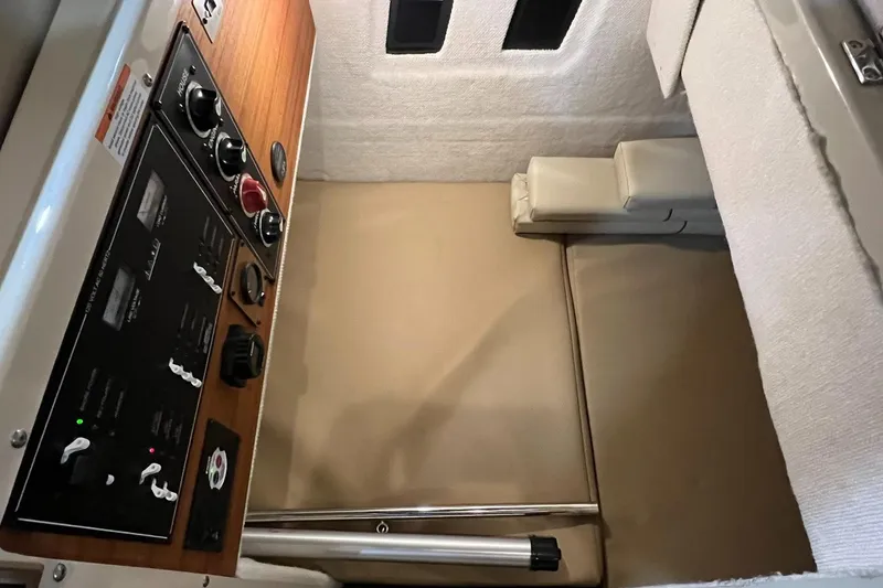 Slide: The Image of 2023 Ranger Tugs R-25 interior cabin with control panel and seating area. - 9