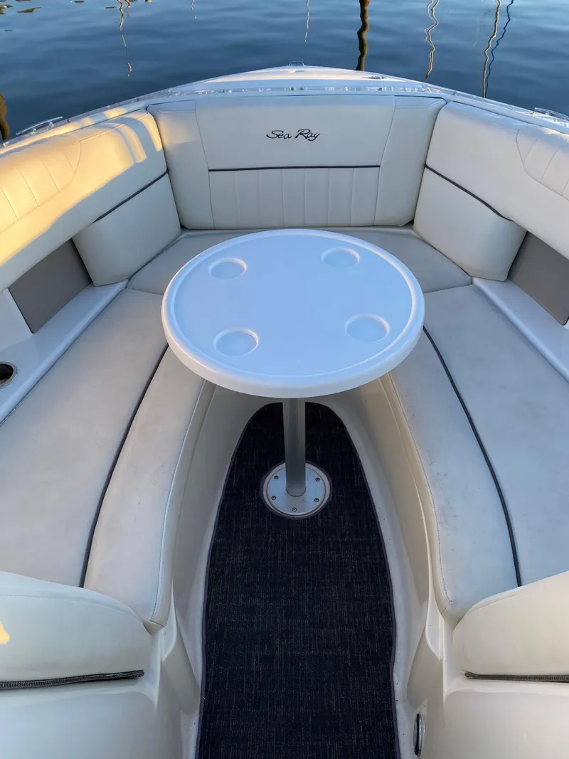 Slide: The Image of 2006 Sea Ray 270 SLX boat interior with round table and cushioned seating. - 4