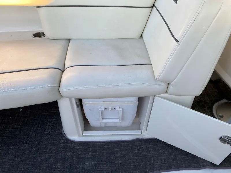 Slide: The Image of White leather seating with storage compartment on 2006 Sea Ray 270 SLX boat. - 5