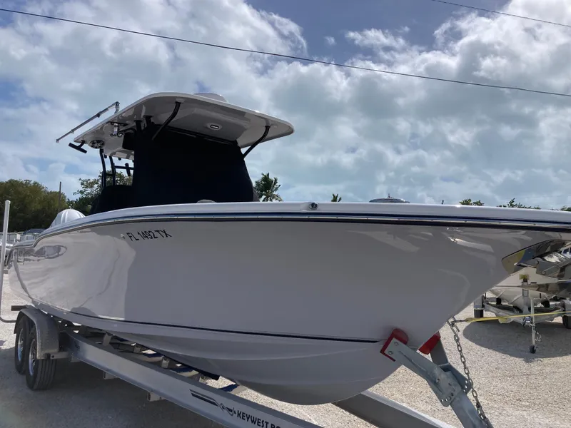 Slide: The Image of 2025 Key West 291FS boat on trailer under cloudy sky. - 1
