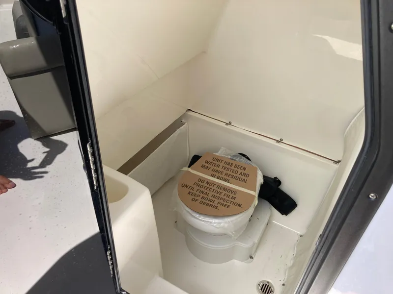 Slide: The Image of 2025 Key West 291FS boat interior with compact marine toilet. - 14