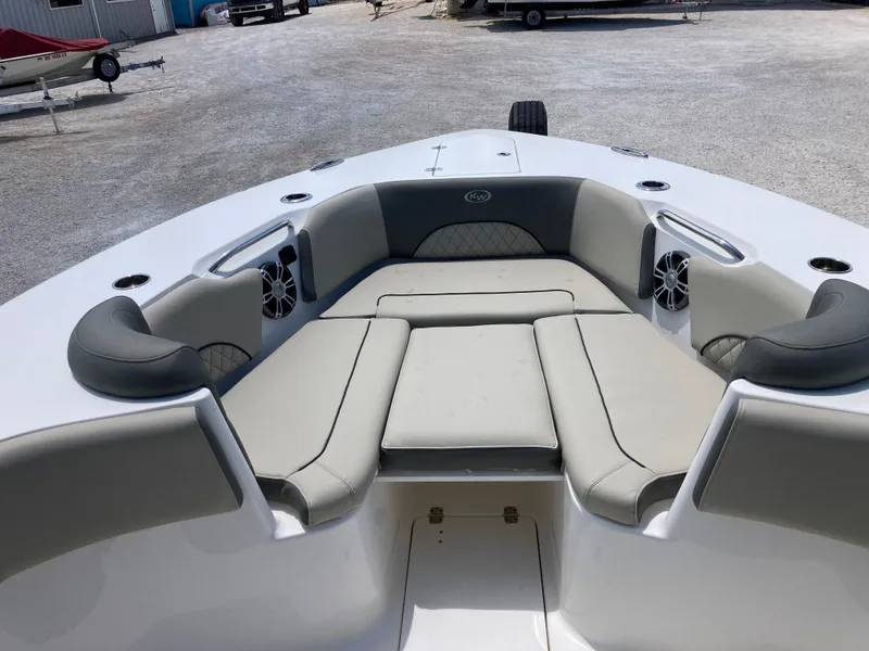 Slide: The Image of 2025 Key West 291FS boat interior with cushioned seating and built-in speakers. - 15