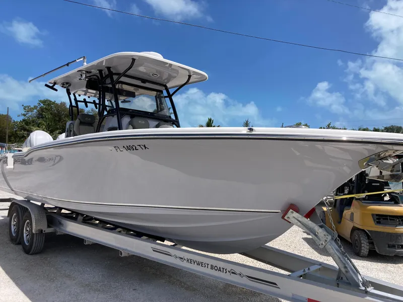 Slide: The Image of 2025 Key West 291FS boat on trailer under clear blue sky. - 2