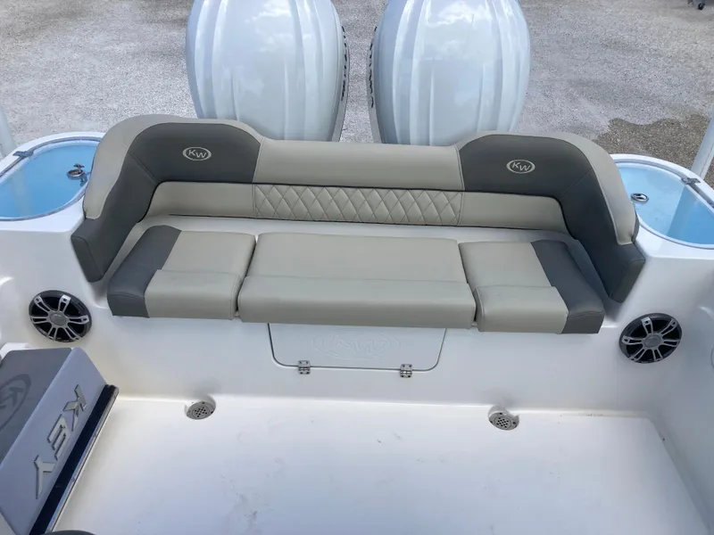 Slide: The Image of 2025 Key West 291FS boat seating area with cushioned bench and integrated speakers. - 22