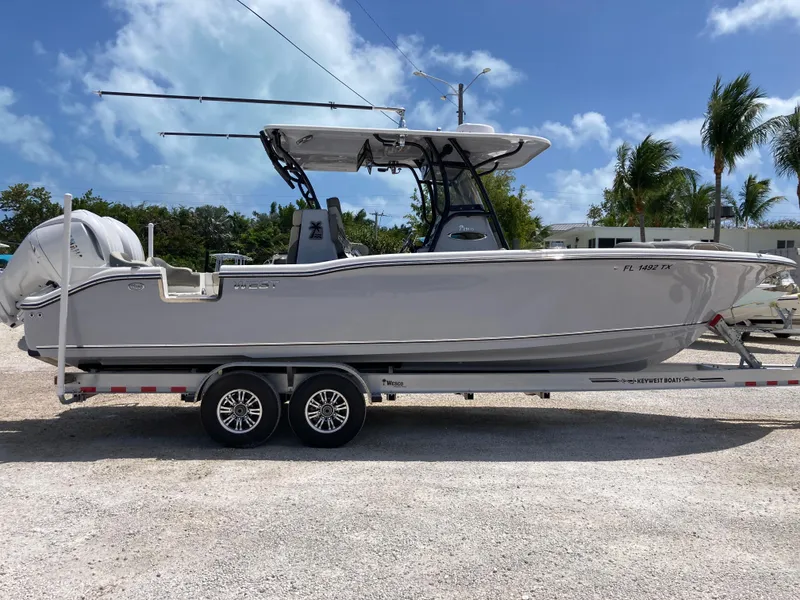 Slide: The Image of 2025 Key West 291FS boat on trailer, parked outdoors under clear sky. - 3