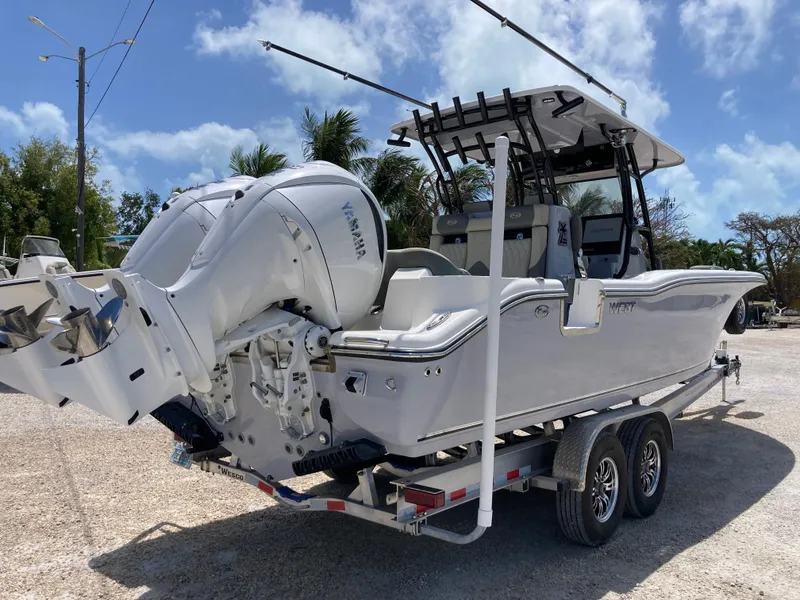 Slide: The Image of 2025 Key West 291FS boat on trailer, featuring dual Yamaha engines, parked outdoors. - 4
