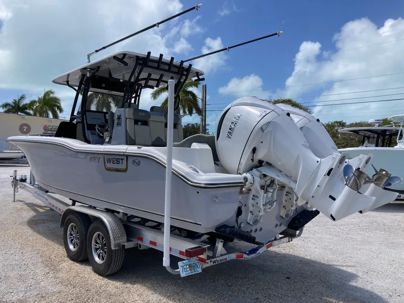 Slide: The Image of 2025 Key West 291FS boat on trailer with Yamaha outboard motor, parked outdoors. - 5