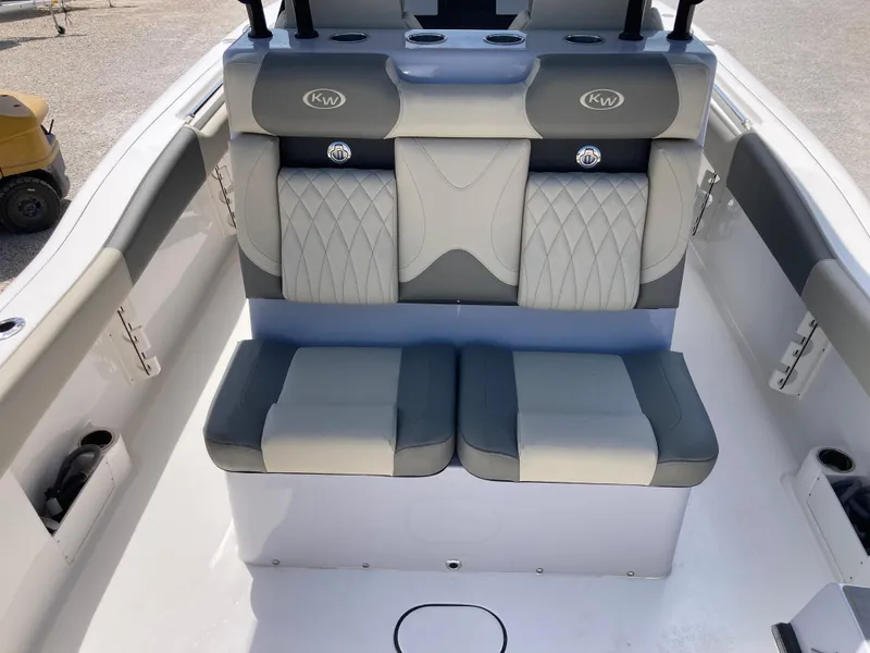 Slide: The Image of 2025 Key West 291FS boat interior with gray cushioned seating and cup holders. - 7