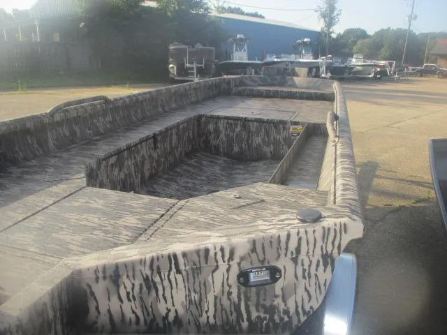 Slide: The Image of 2025 Reaper Boats 756-1381 model with camouflage design, parked outdoors. - 5