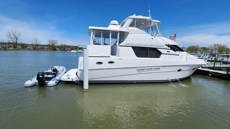Slide: The Image of 2001 Silverton 453 Motor Yacht docked on calm water under clear blue sky. - 1