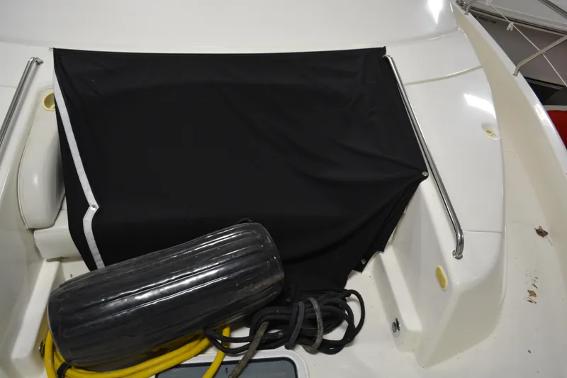 Slide: The Image of 2001 Silverton 453 Motor Yacht deck with black cover and marine equipment. - 13