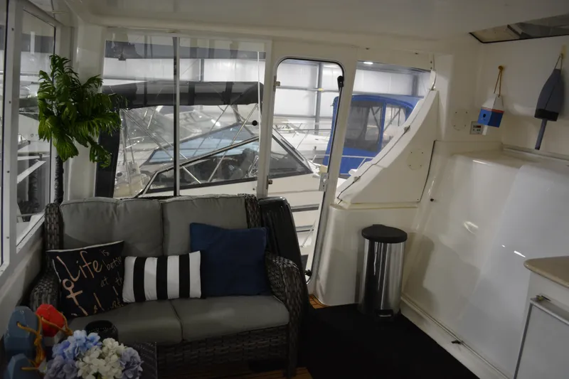 Slide: The Image of Interior of 2001 Silverton 453 Motor Yacht with cozy seating and nautical decor. - 24