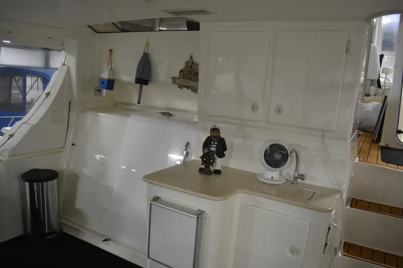 Slide: The Image of 2001 Silverton 453 Motor Yacht interior with cabinets, fan, and nautical decor. - 25