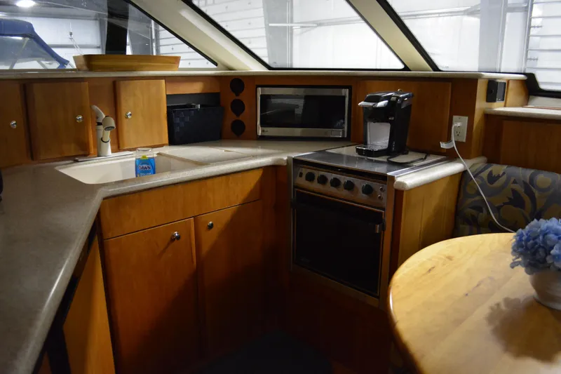 Slide: The Image of Interior of 2001 Silverton 453 Motor Yacht kitchen with appliances and wooden cabinetry. - 29