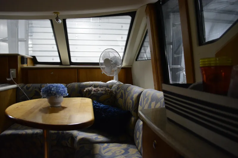 Slide: The Image of Interior of 2001 Silverton 453 Motor Yacht with cozy seating and table. - 32