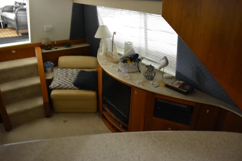 Slide: The Image of Interior of 2001 Silverton 453 Motor Yacht with cozy seating and entertainment area. - 34