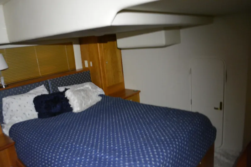 Slide: The Image of Interior cabin of 2001 Silverton 453 Motor Yacht with cozy bed and wooden accents. - 37