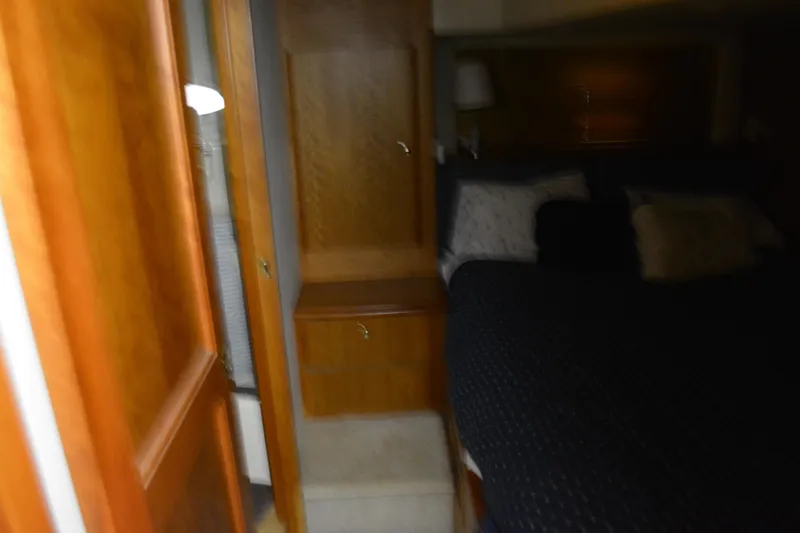 Slide: The Image of Interior cabin of 2001 Silverton 453 Motor Yacht with wooden cabinetry and bed. - 38
