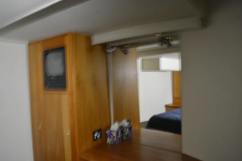 Slide: The Image of Interior of 2001 Silverton 453 Motor Yacht with wood cabinetry and built-in TV. - 39