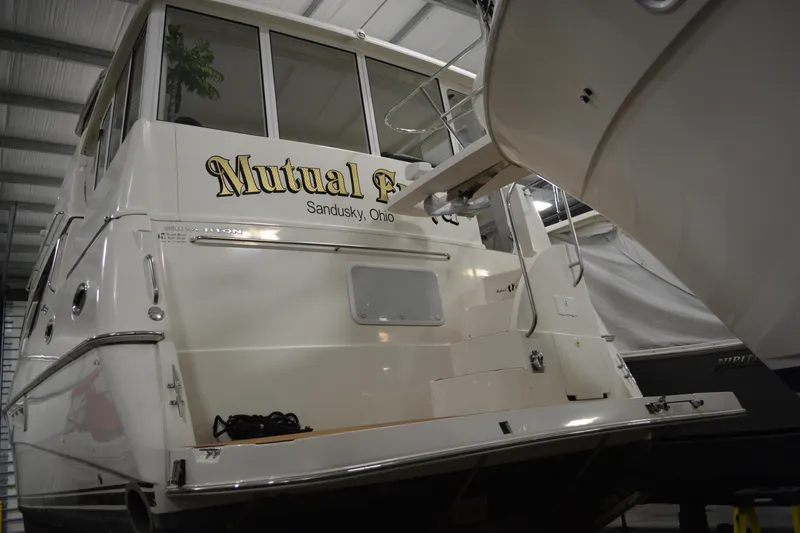 Slide: The Image of 2001 Silverton 453 Motor Yacht docked indoors, rear view with "Mutual Fun" signage. - 4