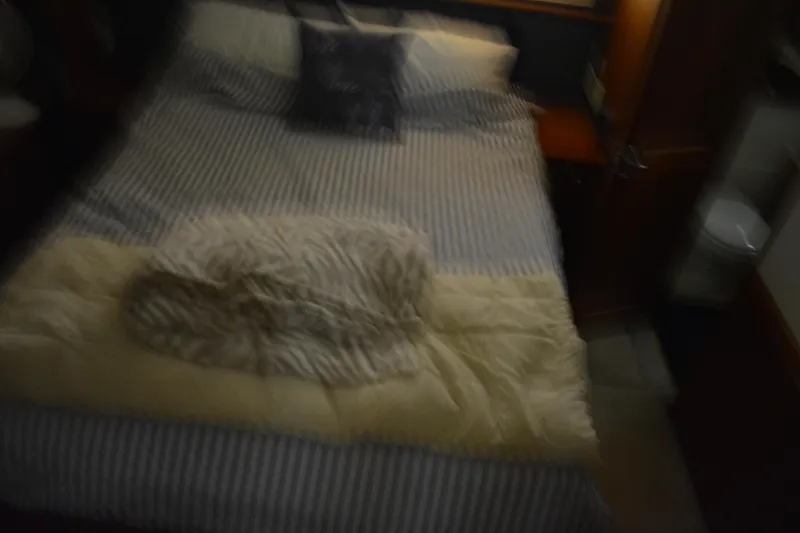 Slide: The Image of Blurred interior of 2001 Silverton 453 Motor Yacht bedroom with striped bedding. - 40