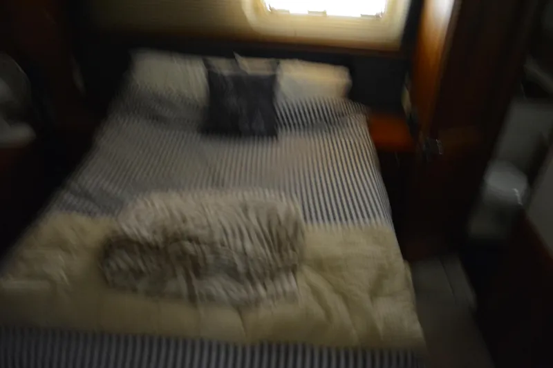 Slide: The Image of Blurry interior of 2001 Silverton 453 Motor Yacht bedroom with striped bedding. - 41
