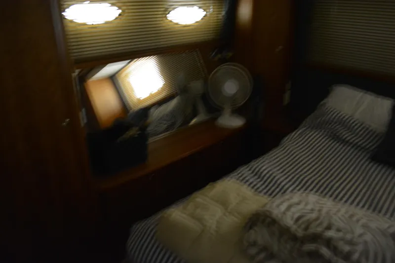 Slide: The Image of Cozy bedroom in 2001 Silverton 453 Motor Yacht with striped bedding and a small fan. - 42