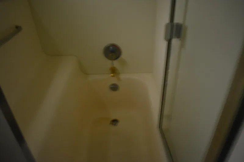 Slide: The Image of Shower area inside 2001 Silverton 453 Motor Yacht, featuring a glass door and fixtures. - 45