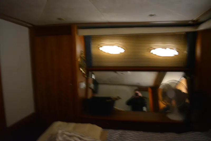 Slide: The Image of Interior of 2001 Silverton 453 Motor Yacht with wood paneling and window blinds. - 48