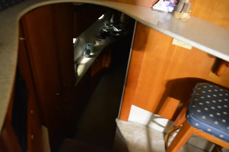 Slide: The Image of Interior view of 2001 Silverton 453 Motor Yacht with wooden cabinetry and bar stool. - 49