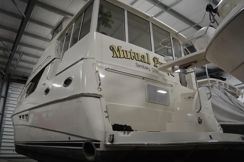 Slide: The Image of 2001 Silverton 453 Motor Yacht in storage, rear view, labeled "Mutual Fun," Sandusky, Ohio. - 5