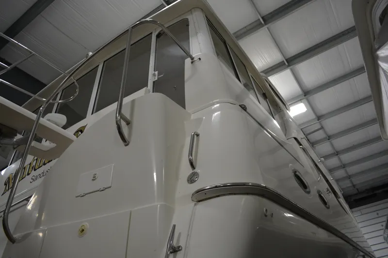 Slide: The Image of 2001 Silverton 453 Motor Yacht in indoor storage, showcasing sleek design and structure. - 7